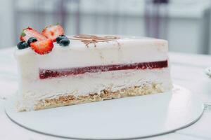 A slice of mousse cake in the cut. Making a cake at a culinary master class. Cooking at home, homemade food photo