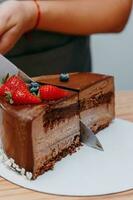 A piece of chocolate cake in the cut. Preparation of mousse cake at a culinary master class. Cooking at home, homemade food photo