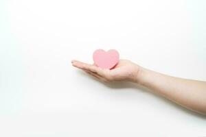 paper pink heart on adult hand on white background , valentine day,love , happy, holiday, romantic, world heart day, world health day, praying concept photo