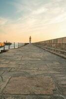 Farolim de Felgueiras, Pier and lighthouse at Porto, Portugal During sunset. photo