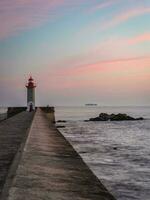 Farolim de Felgueiras, Pier and lighthouse at Porto, Portugal During sunset. photo