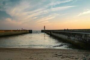 Farolim de Felgueiras, Pier and lighthouse at Porto, Portugal During sunset. photo