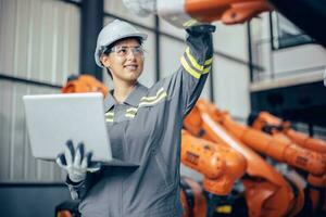 Engineer woman team worker work in Machine Robotic modern Automation Industry. Mechanic staff employee in metal factory. photo