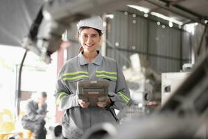 Engineer woman team worker work in Machine Robotic modern Automation Industry. Mechanic staff employee in metal factory. photo