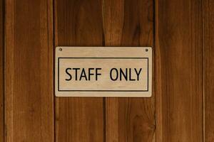 STAFF ONLY wood text badge sign banner on wooden door panel background. photo