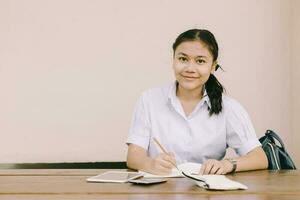 portrait southeast asian young teen student sitting education learning in school uniform with copy space. photo