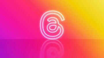 Madrid, Spain - July, 2023. Threads logo in neon on gradient background with space for text and graphics. photo