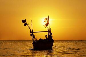 a boat in the sea with sunset sky photo