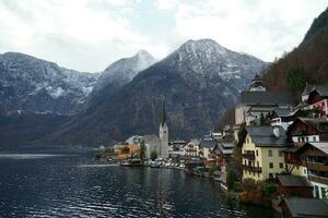 Stunning view of the Hallstatt village surrounded by mountains and beautiful nature in winter photo
