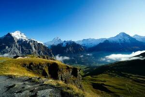 Beautiful view of nature trail in the morning, Grindelwald First, Highest peaks Eiger, Switzerland Alps. For trekking, hiking, mountaineering or nature walk activities. photo