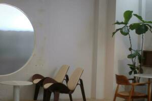 a round window with a chair and table in front of it photo