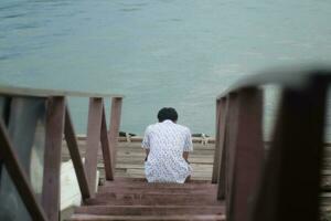 person alone watching the sea photo