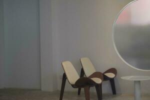 a round window with a chair and table in front of it photo