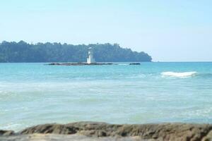 a view of the sea and the beach lighthouse photo