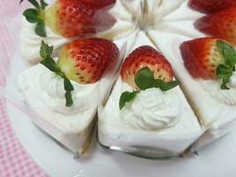 Strawberry cake with whipped cream and fresh strawberries on white plate photo