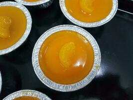orange custard in tin cups photo