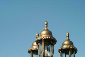 old lantern on the background of blue sky photo