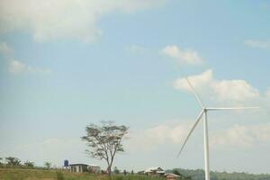 white windmill on blue sky background. energy concept. photo