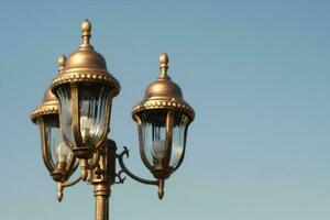 old lantern on the background of blue sky photo