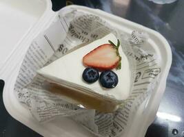 Strawberry cake with whipped cream and fresh strawberries on white plate photo