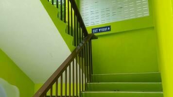 Staircase with green wall and blue sign in modern house. photo