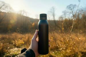 Thermo bottle hand nature. Generate Ai photo