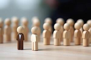 Figurine of a businessman standing in front of a group of people. photo