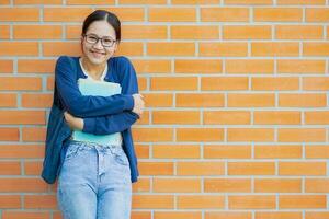linda sonriente risa tímido asiático Universidad adolescente niña estudiante educación en Universidad sincero disparo. foto