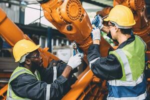 Engineer working service maintenance robot arm welding in assembly line automation factory industry. photo