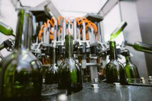 Drink Beverage or Winery Brewery factory production line, Bottle cleaning machine process. photo