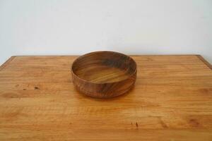 Wooden bowl on the table photo