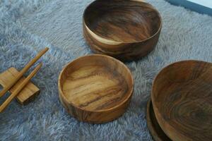 Wooden bowl on grey background photo