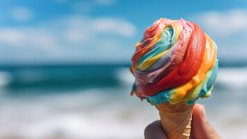 Close-up of hand holding colorful rainbow ice cream in waffle cone, refreshing sweet dessert on sunny day on beach at sea, copy space. Generative AI photo