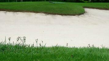 Golf Course Sand Pit Bunkers, green grass surrounding the beautiful sand holes is one of the most challenging obstacles for golfers and adds to the beauty of the golf course. video