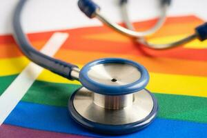 Stethoscope on rainbow flag background, symbol of LGBT pride month celebrate annual in June social, symbol of gay, lesbian, bisexual, transgender, human rights and peace. photo