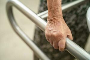 Asian elderly woman patient use toilet bathroom handle security in nursing hospital, healthy strong medical concept. photo