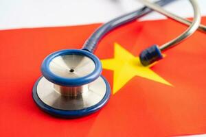 Stethoscope on Vietnam flag background, Business and finance concept. photo