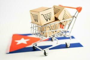 Box with shopping online cart logo and Cuba flag, Import Export Shopping online or commerce finance delivery service store product shipping, trade, supplier concept. photo