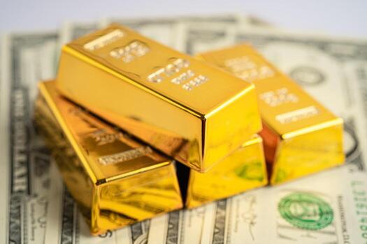 Gold bar on US dollar banknotes money, economy finance exchange trade investment concept. photo