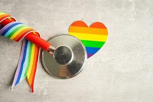 Stethoscope with heart and rainbow flag, symbol of LGBT pride month celebrate annual in June social, symbol of gay, lesbian, bisexual, transgender, human rights and peace. photo