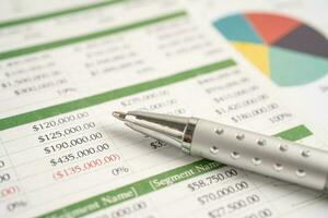 Pen on chart or graph paper. Financial, account, statistics and business data concept. photo