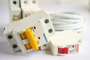 Automatic circuit breaker on white background, control and protect electrical power system. photo