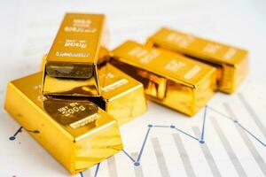 Gold bar on graph, economy finance exchange trade investment concept. photo