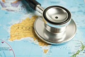 Bangkok, Thailand June 1, 2022, Stethoscope on Australia world globe map background. photo