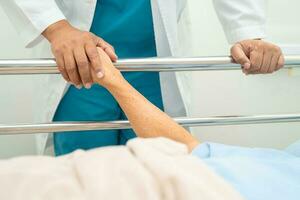 Doctor checking the patient lie down on a bed in the hospital, healthy strong medical concept. photo