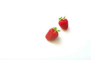 Two strawberries isolated on white background. Menu concept, copy space, place for text. top view photo