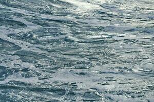 Dark foaming waves of stormy sea, background photo