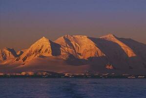 Lemaire strait coastal landscape, mountains and icebergs, Antarctic Peninsula, Antartica. photo