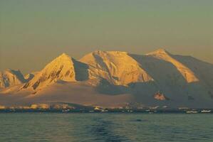 lemaire estrecho costero paisaje, montañas y icebergs, antártico península, Antártida. foto