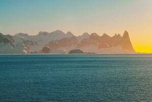 Lemaire strait coast, mountains and icebergs, Antartica photo